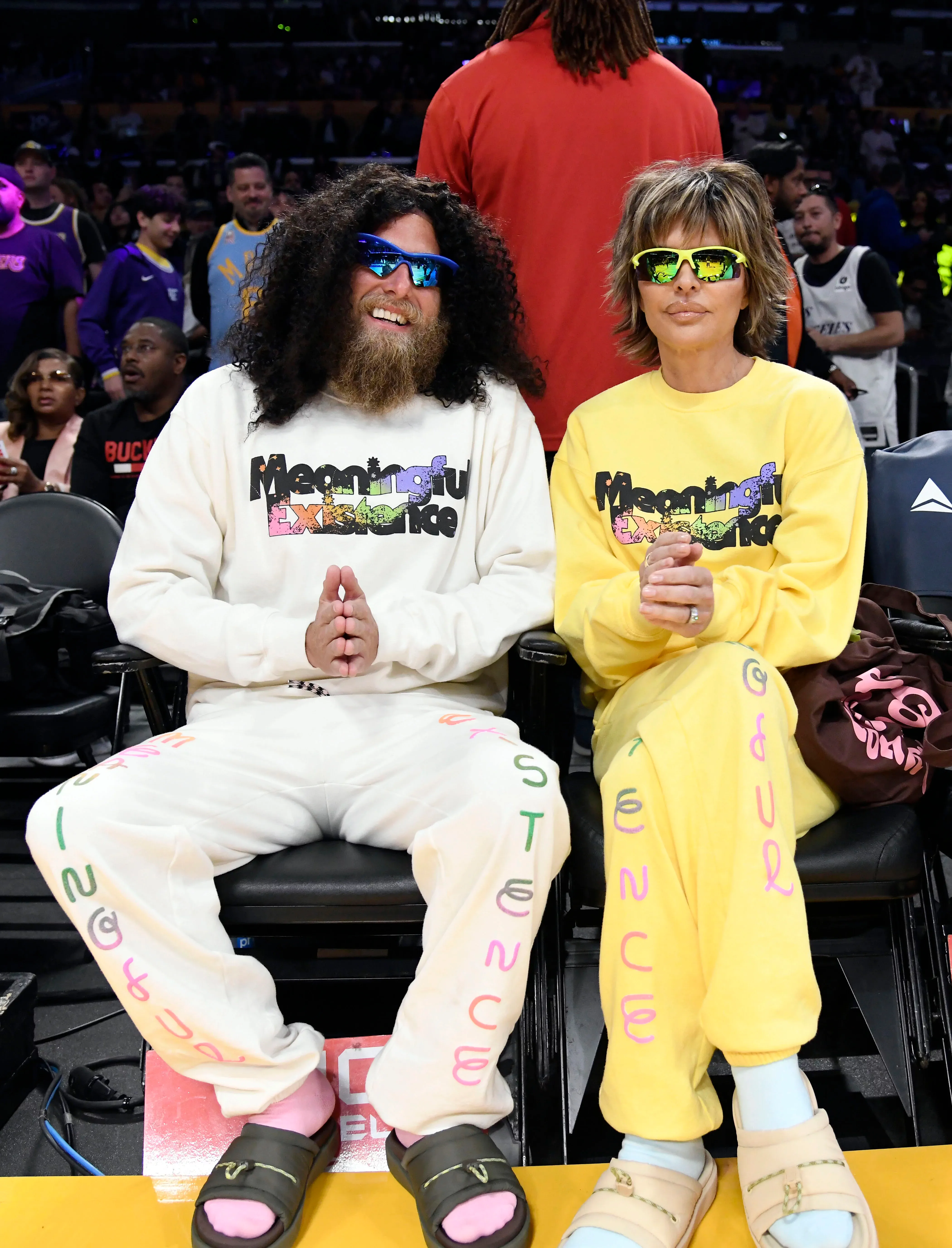 Prophet and Lisa sitting courtside at a basketball game.