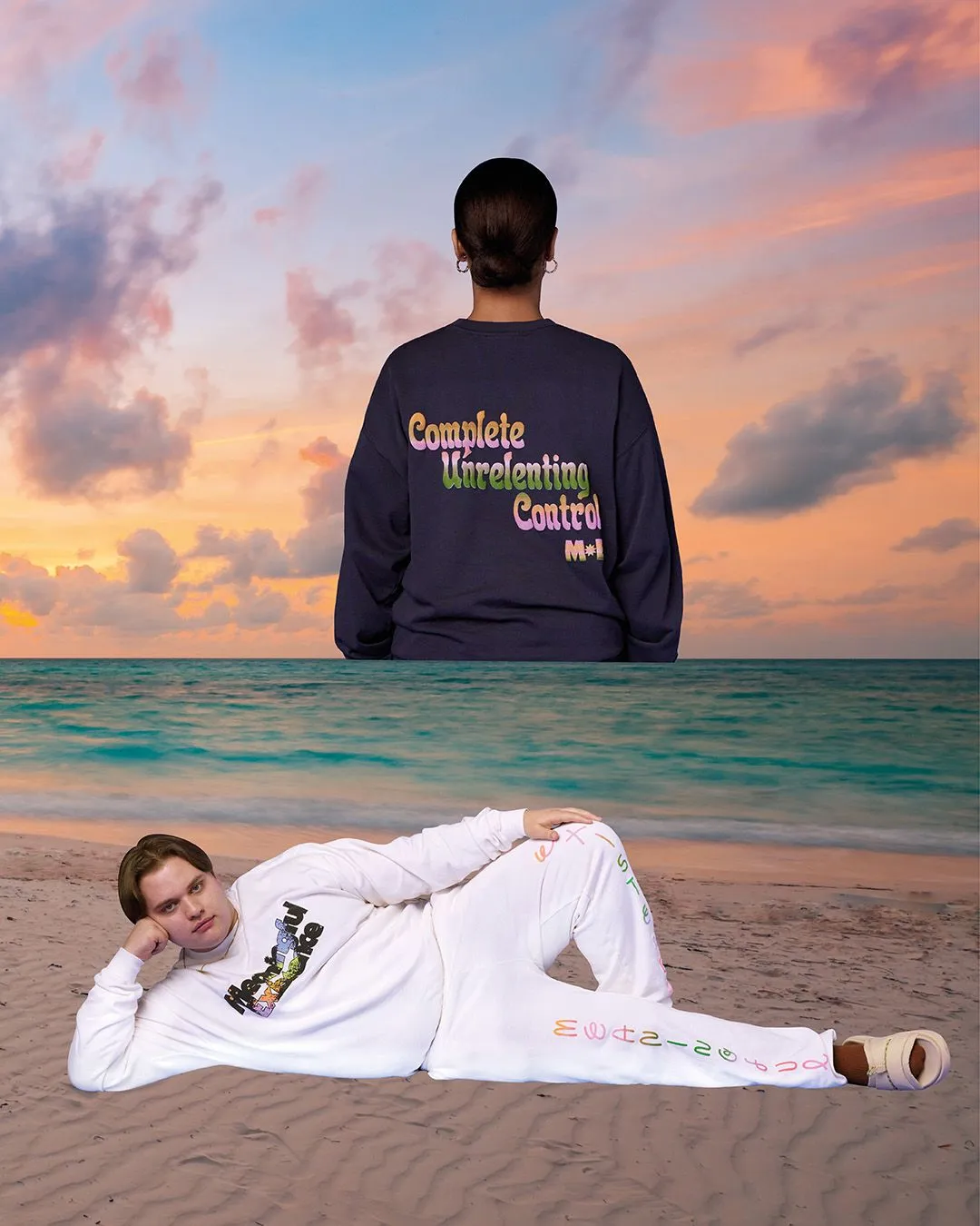 A person lies on the beach at sunset modeling a Meaningful Existence sweatsuit. On the horizon, another model rises out of the ocean wearing a tee that says "Complete Unrelenting Control"
