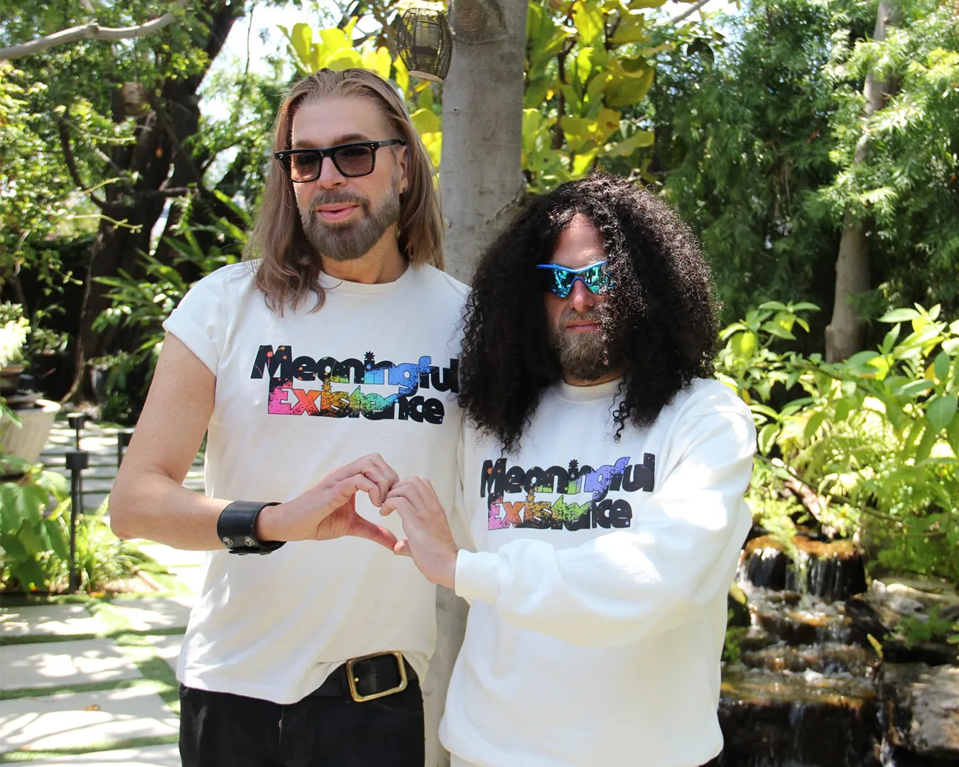 Prophet Profit making a hand-heart with Chaz Dean, celebrity hairstylist