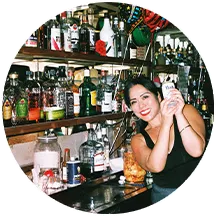 A bartender at Monte Carlo holding up a beer