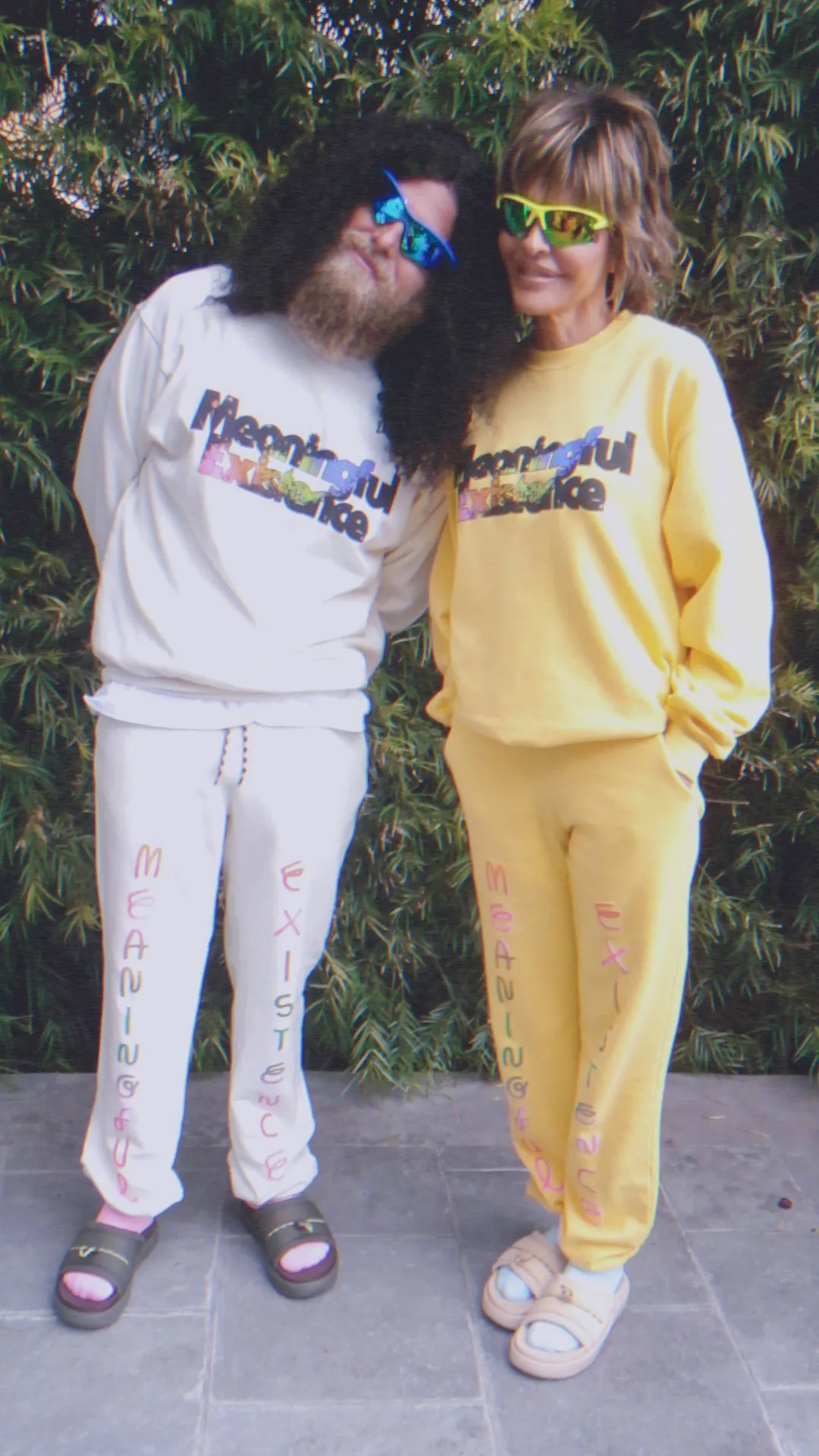 Lisa Rinna and Profit standing in matching sweatsuits